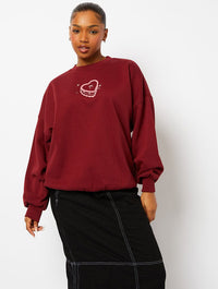 Feed Me Cake Sweatshirt in Burgundy Hoodies & Sweatshirts Skinnydip London