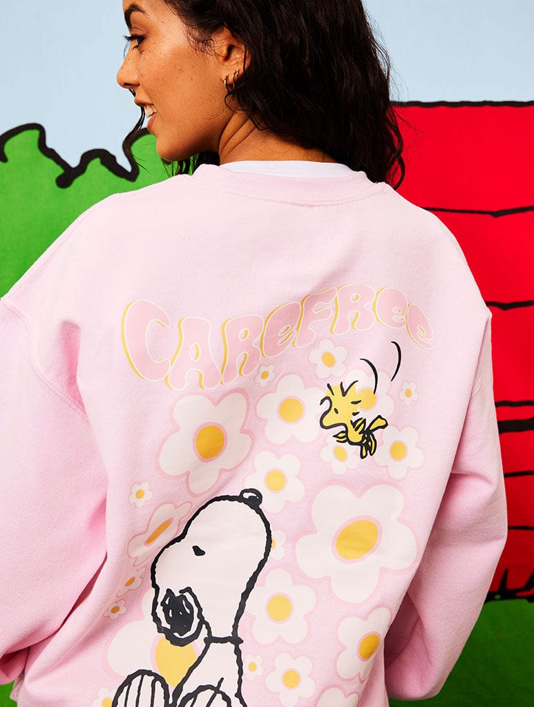 Peanuts x Skinnydip Snoopy Carefree Sweatshirt in Pink Hoodies & Sweatshirts Skinnydip London