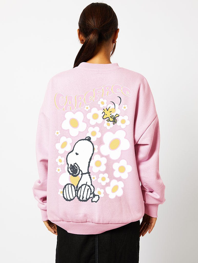 Peanuts x Skinnydip Snoopy Carefree Sweatshirt in Pink Hoodies & Sweatshirts Skinnydip London