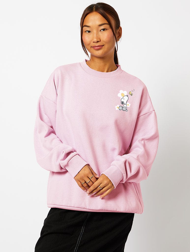 Peanuts x Skinnydip Snoopy Carefree Sweatshirt in Pink Hoodies & Sweatshirts Skinnydip London